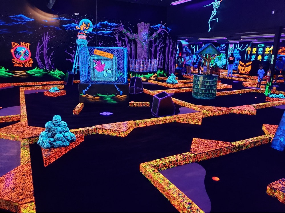 A glow-in-the-dark indoor golf course at Monster Mini Golf.