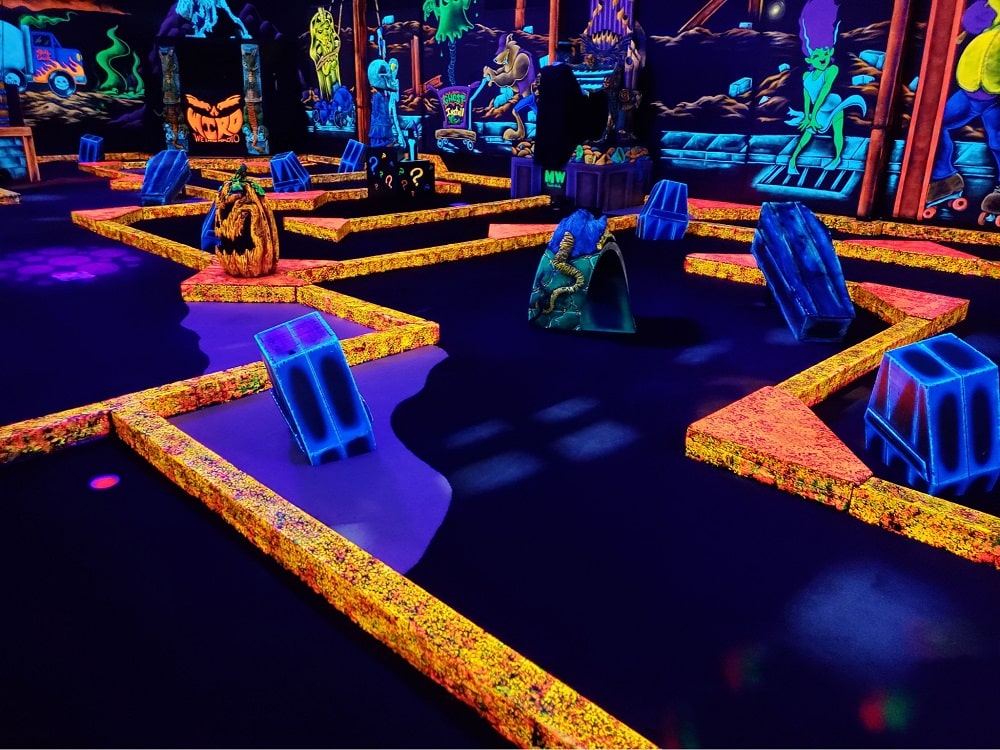 A glow-in-the-dark golf course at Monster Mini Golf.
