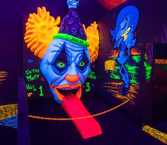 glowing clown head at putt putt course at monster mini golf