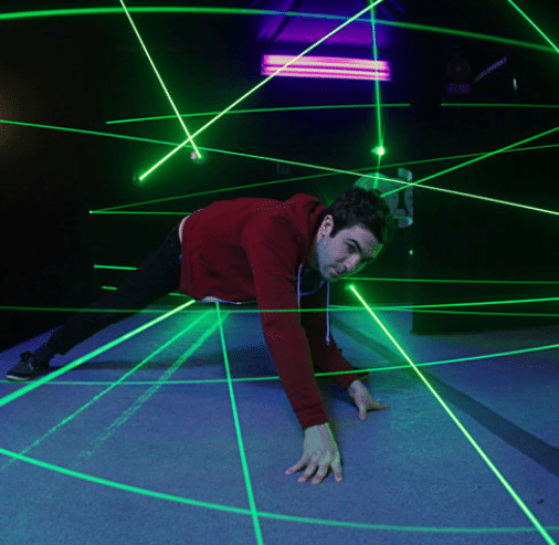 An adult doing the laser maze challenge at Monster Mini Golf.