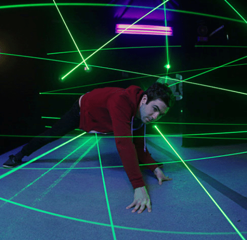 An adult doing the laser maze challenge at Monster Mini Golf Bellevue