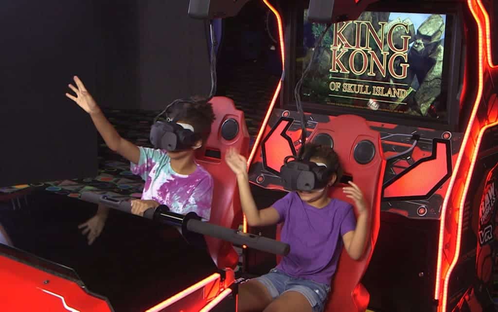 Two kids playing king kong VR game at Monster Mini Golf