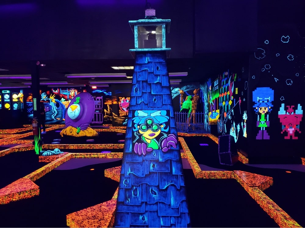 A glow-in-the-dark lighthouse at a Monster Mini Golf location.