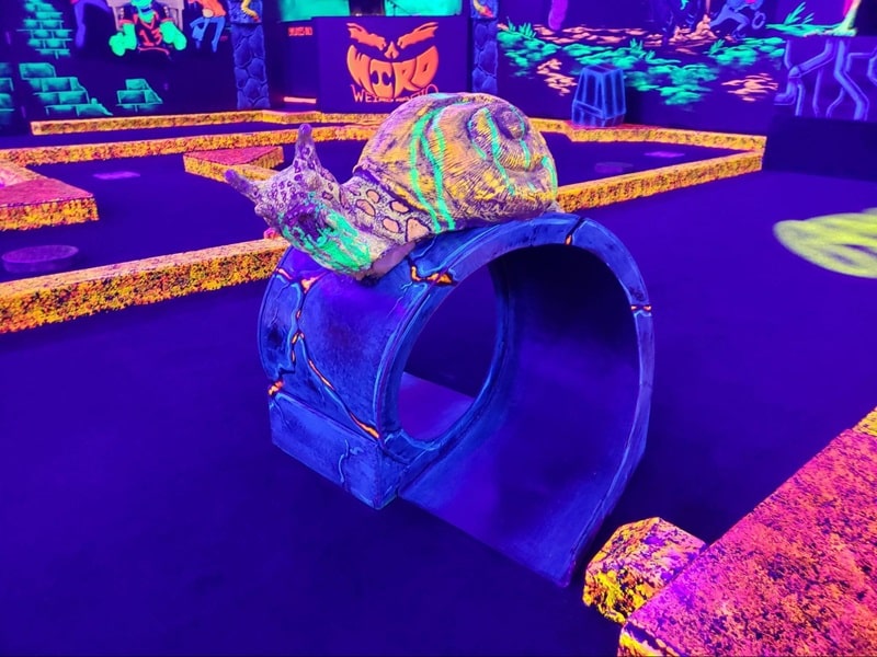 A glow-in-the-dark snail decoration at a Monster Mini Golf location. 