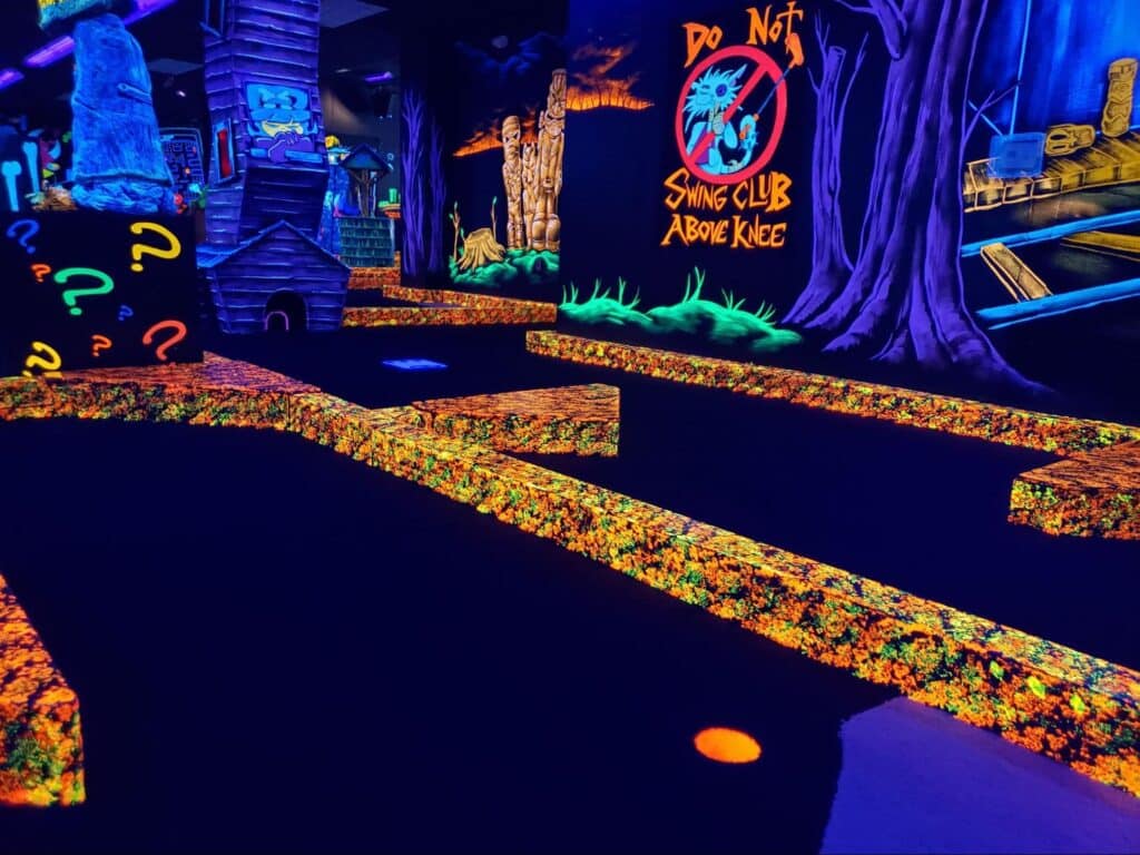 A glow-in-the-dark indoor mini golf course at Monster Mini Golf.