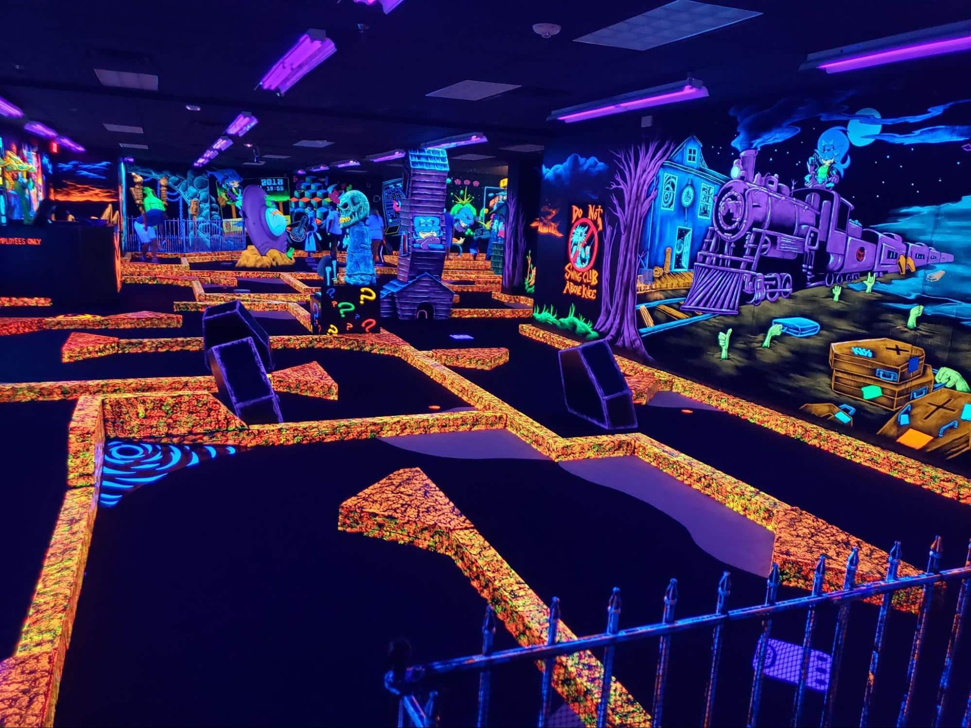 A glow-in-the-dark indoor mini golf course at monster mini golf.