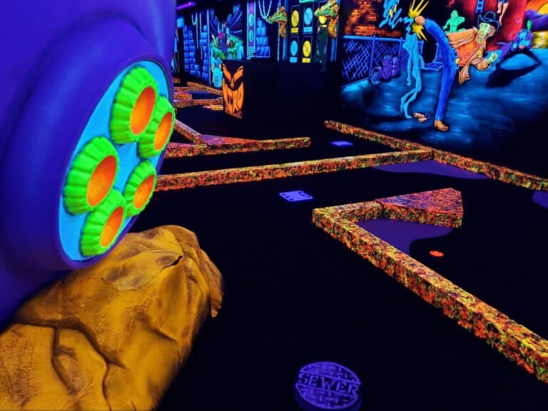 A glow-in-the-dark mini golf course at monster mini golf.