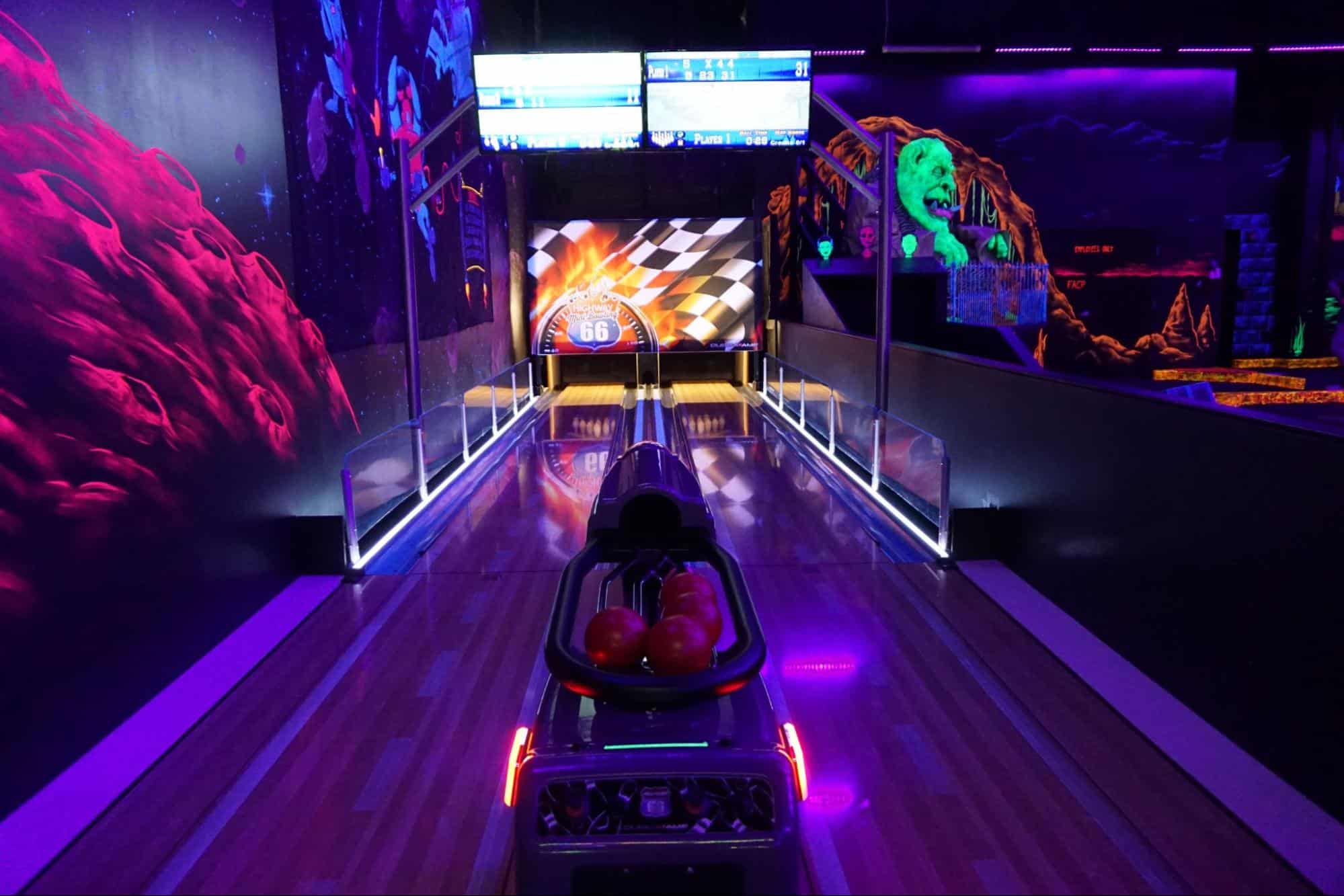 Glow-in-the-dark mini bowling lanes with mini bowling balls at Monster Mini Golf.
