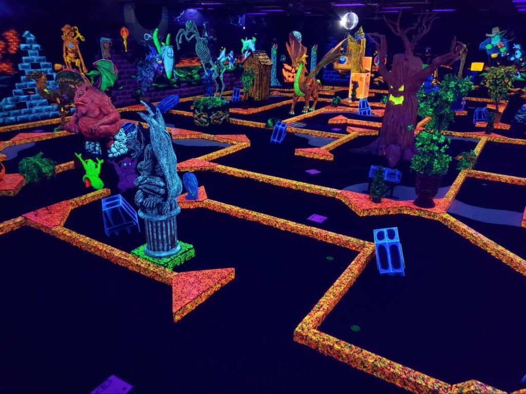 A glow-in-the-dark indoor mini golf course at monster mini golf gastonia.