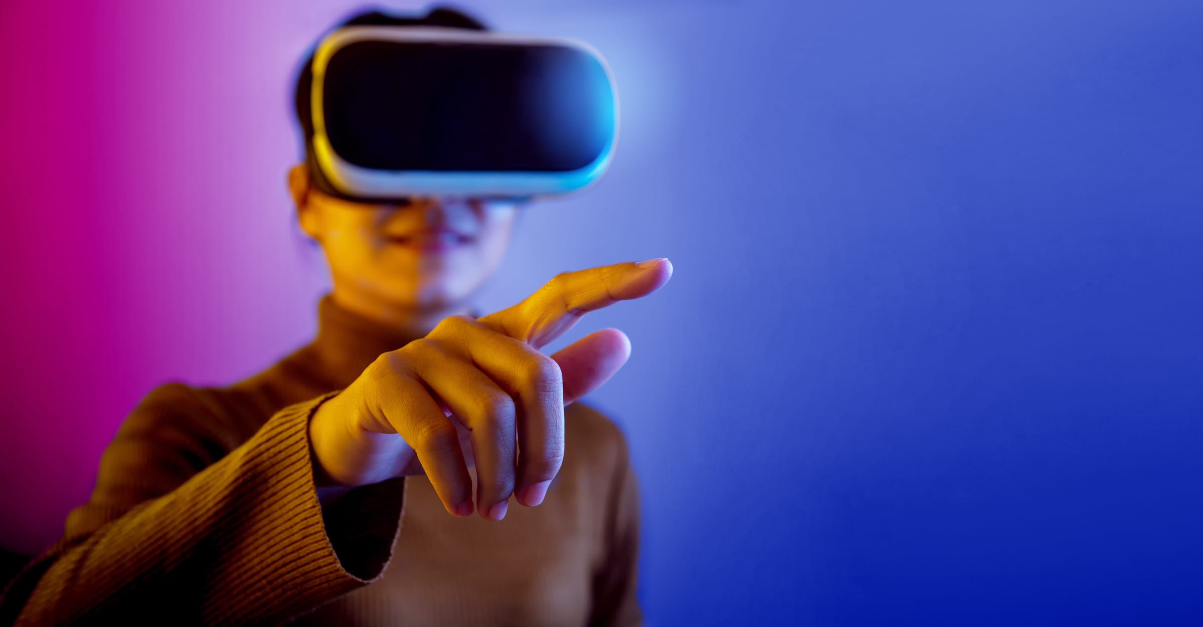 Woman wearing VR glasses pointing finger to do activities in the virtual world.