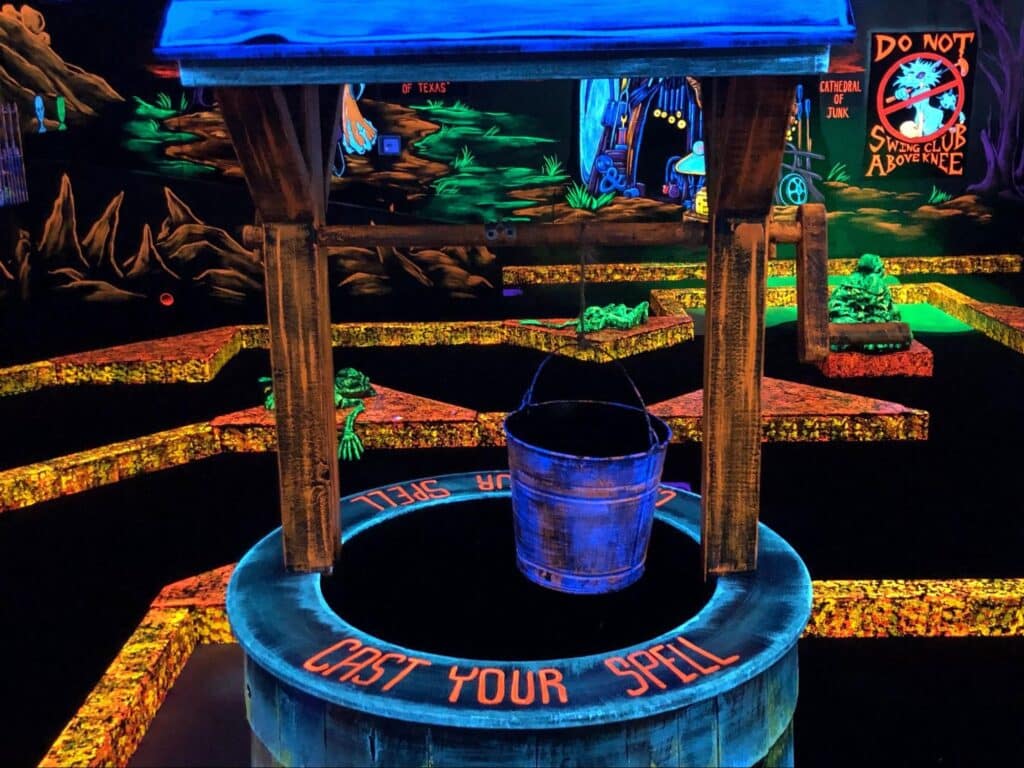 A glow-in-the-dark well decoration at Monster Mini Golf.