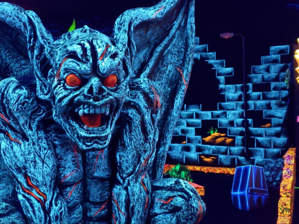 A neon decoration of a gargoyle at Monster Mini Golf.