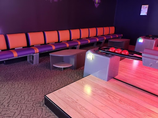 Mini bowling lanes and seating at Monster Mini Golf. 