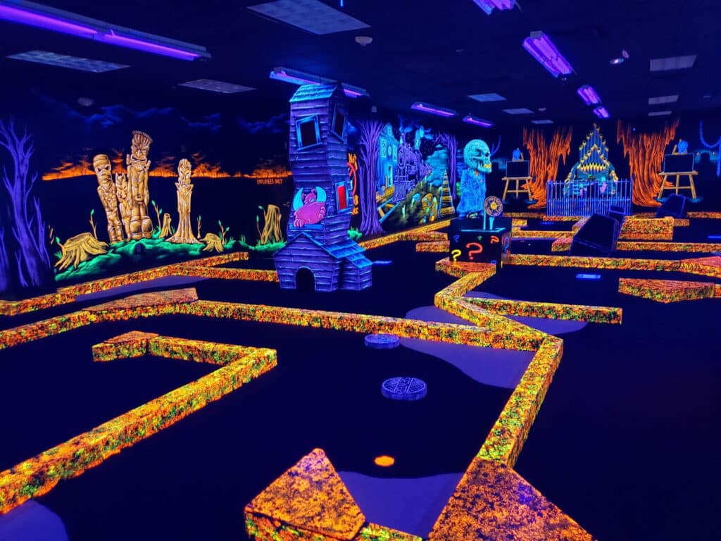 Indoor glow-in-the-dark mini golf course at Monster Mini Golf.