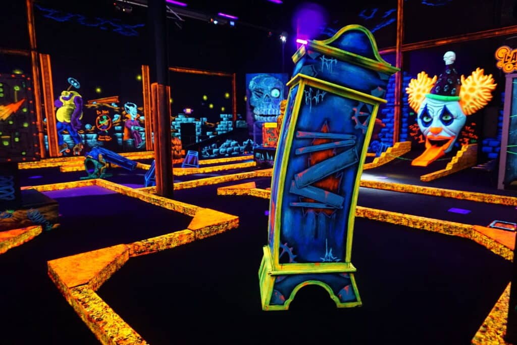 An indoor glow-in-the-dark mini golf course at monster mini golf.