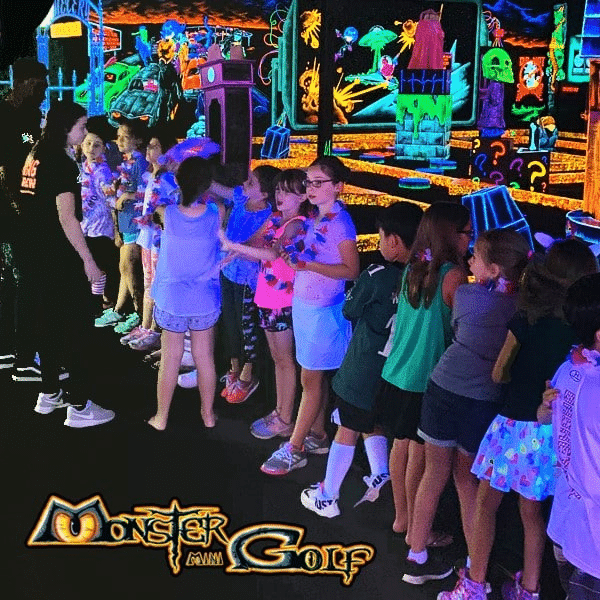 A line of kids celebrating a birthday party at Monster Mini Golf.