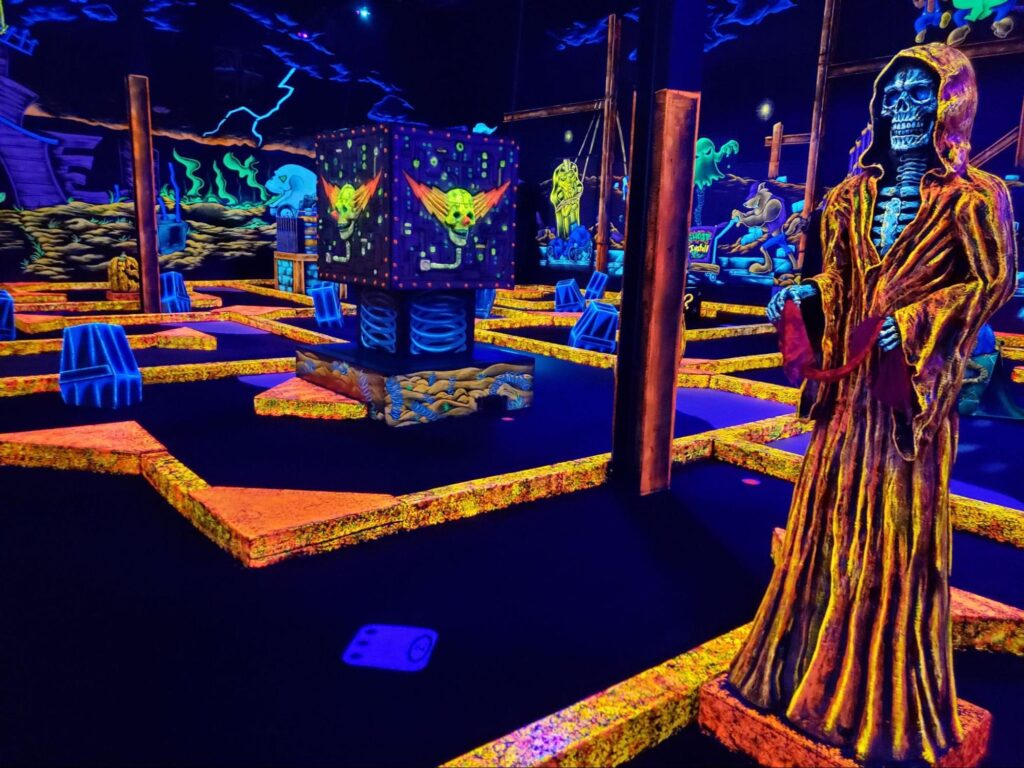 A glow-in-the-dark indoor mini golf course at a Monster Mini Golf location.