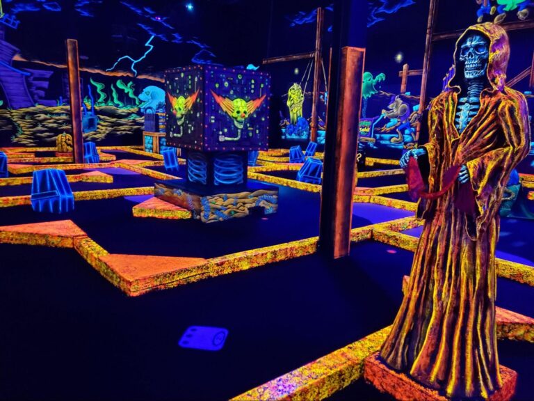 A glow-in-the-dark indoor mini golf course at a monster mini golf location.