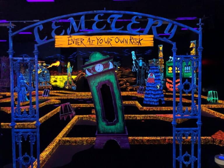 The entrance to a glow-in-the-dark indoor mini golf course at a Monster Mini Golf location.