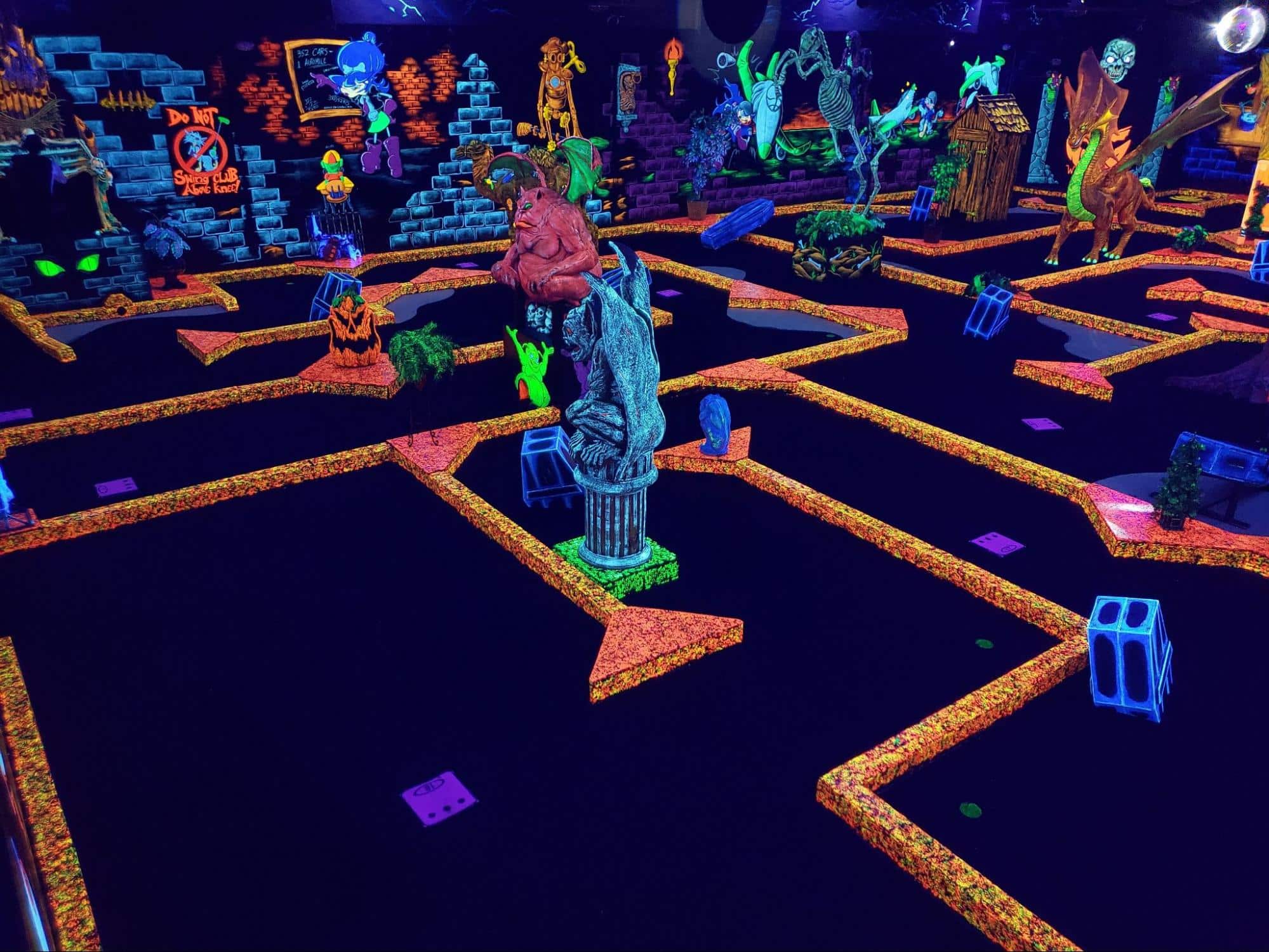 Neon decorations on a glow-in-the-dark indoor mini golf course at Monster Mini Golf.