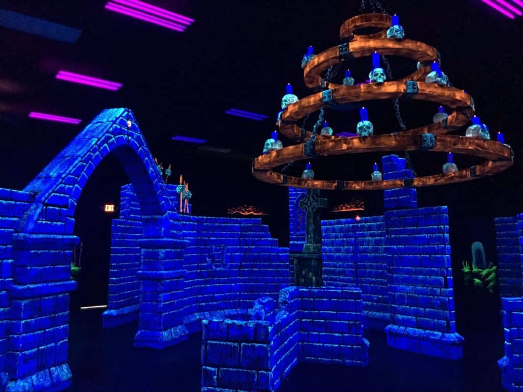 A glow-in-the-dark laser tag venue at a Monster Mini Golf location.