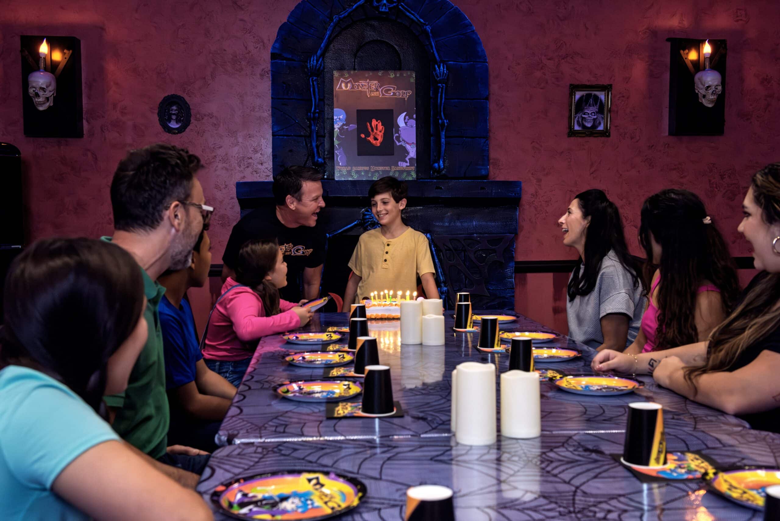 A family celebrates their child's birthday at monster mini golf